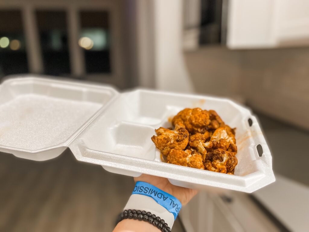 a to-go box holds smoked cauliflower tossed in buffalo sauce, one of the best vegan meals in Nolensville